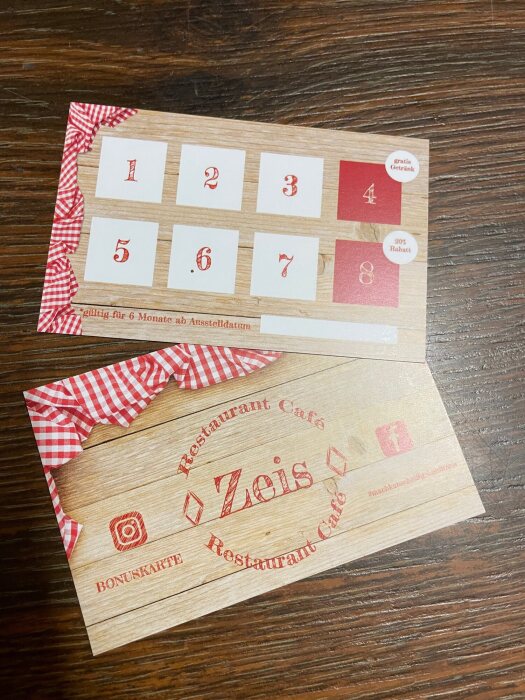 The former Restaurant Café Zeis loyalty card on a wooden table.