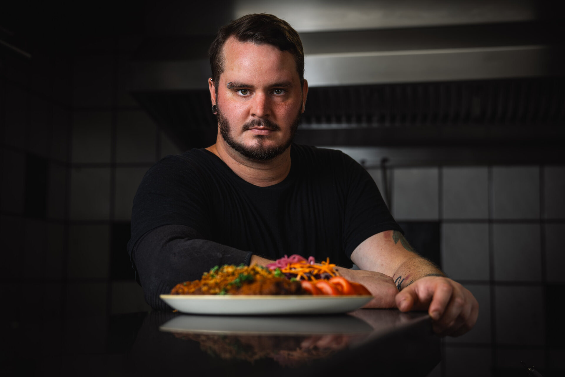 Julian presents a freshly prepared dish in the kitchen at Café Zeis.