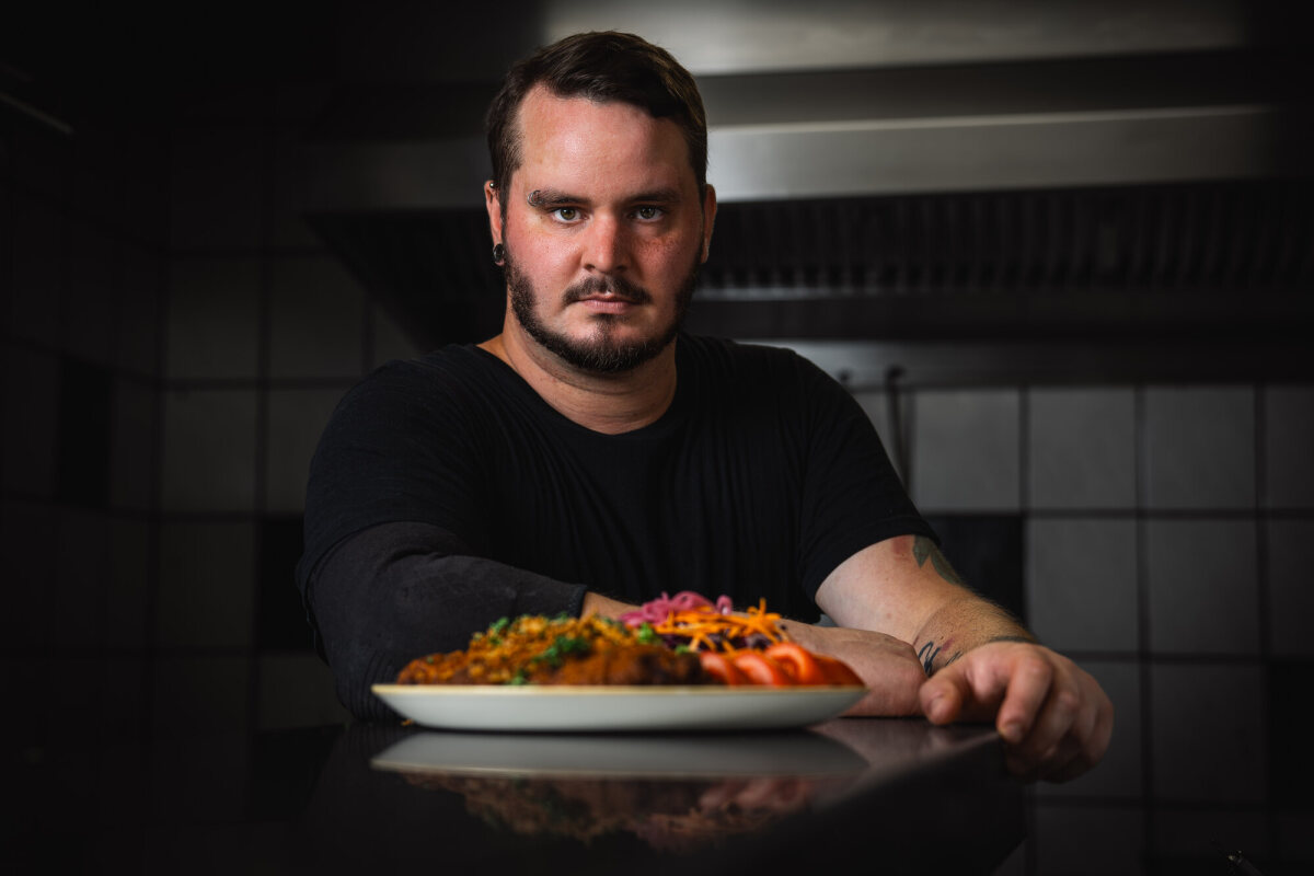 Julian presents a freshly prepared dish in the kitchen at Café Zeis.