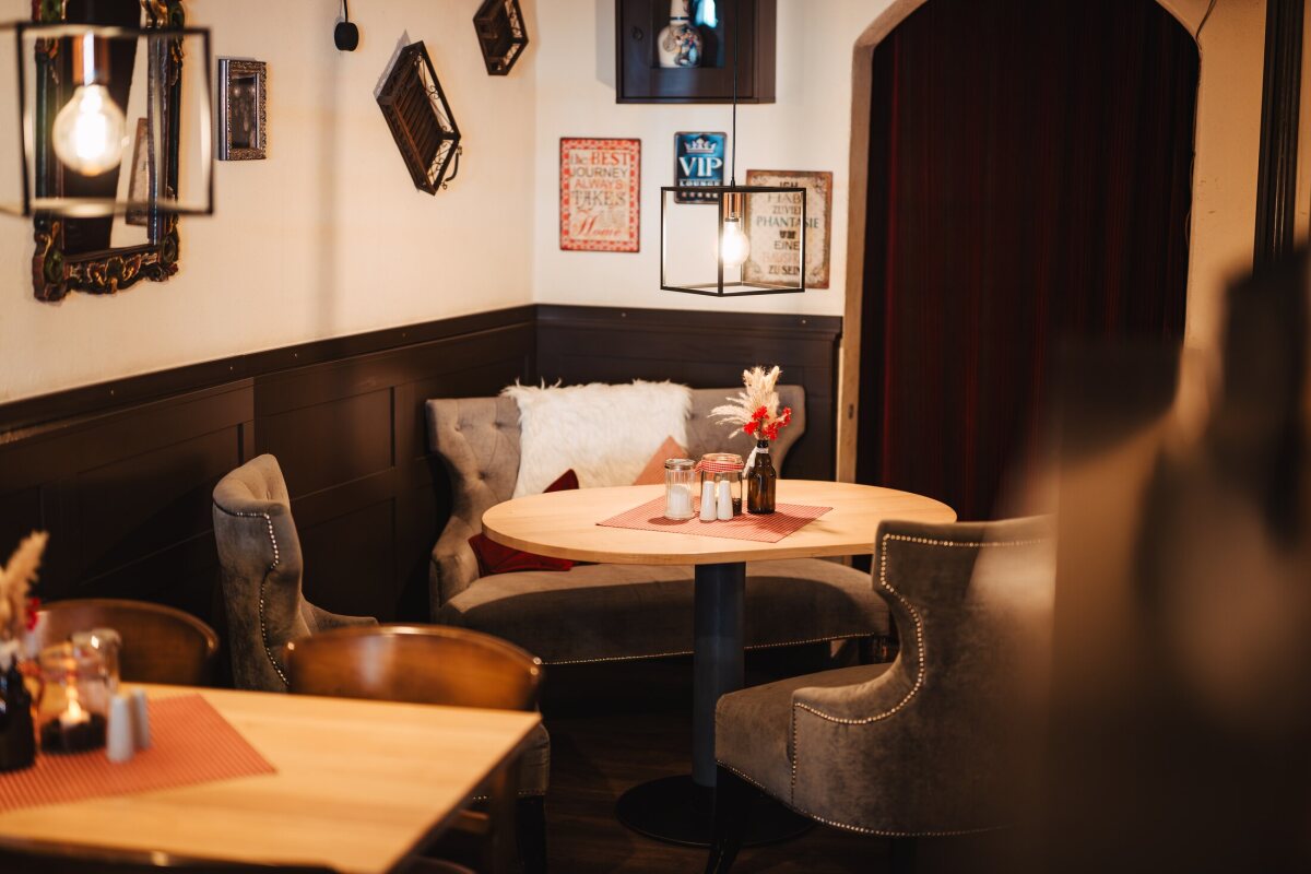 Wooden tables, upholstered seating and warm lights in the dining room at Café Zeis.